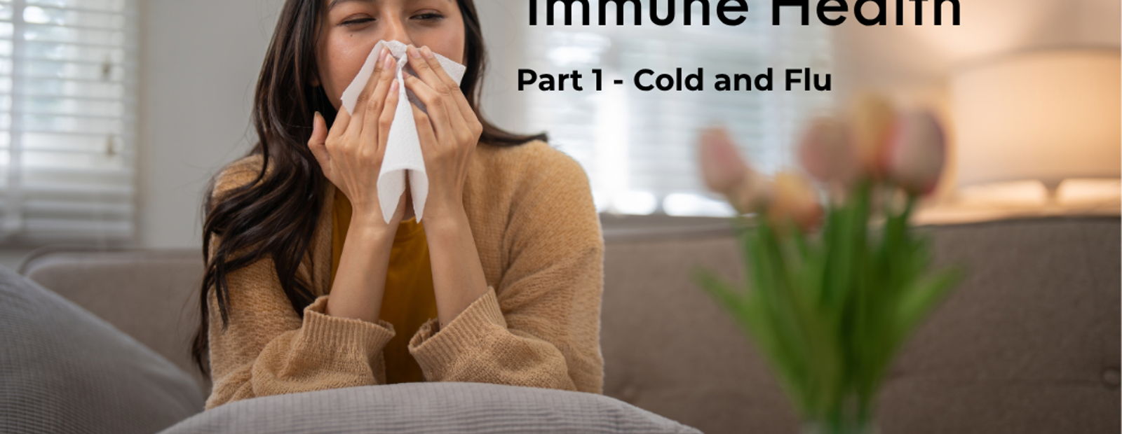 Woman in living room sneezing into tissue; text: “Immune Health Part 1 - Cold and Flu”
