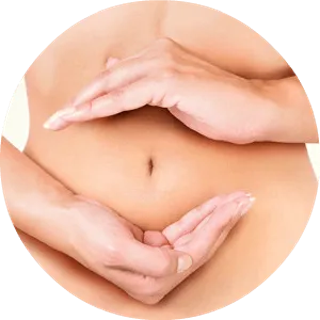 Close-up of hands forming a heart shape around a belly button, symbolizing body care and love.