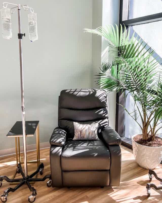 Medical professional with stethoscope, wearing white coat, calm expression.