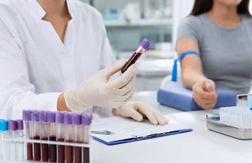 A person undergoing the DAO enzyme blood test in a laboratory setting.