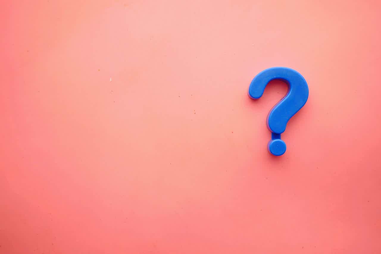 a blue question mark on a pink background - frequently asked questions
