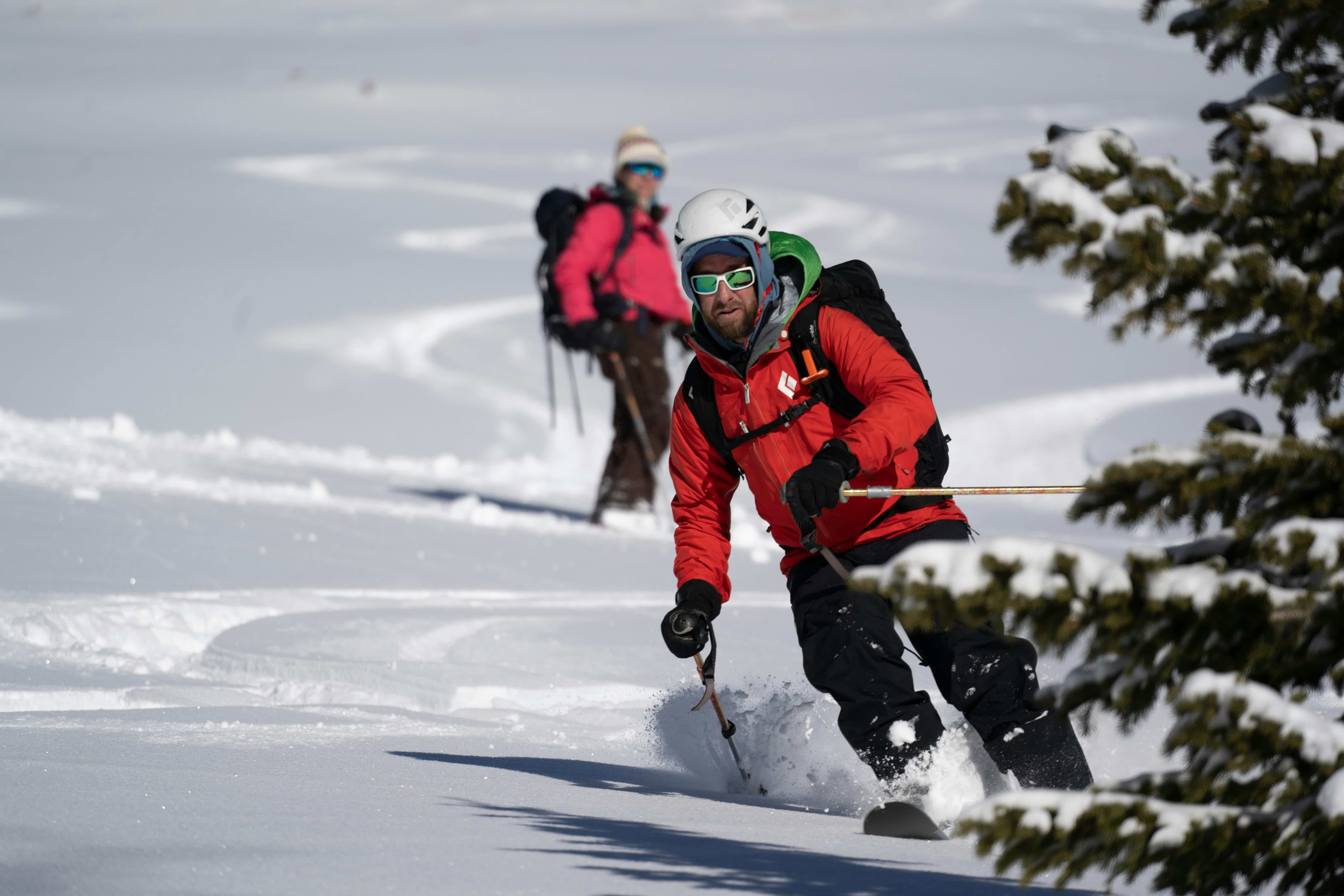 a group of skiers going down a slope