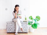Dr. Andrea Gri, ND, eating a fresh salad with a green smoothie