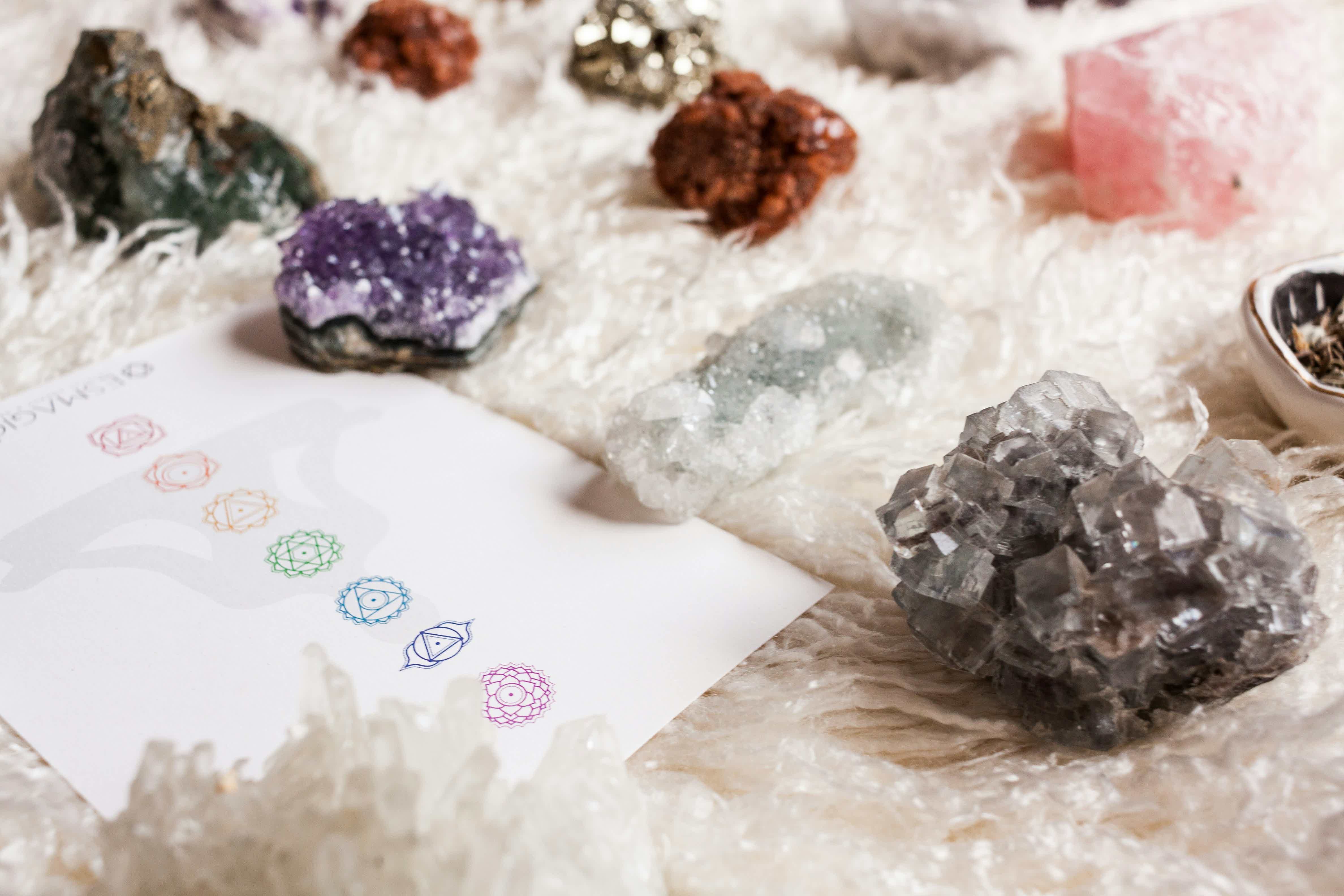 a table topped with chakra stones and symbols