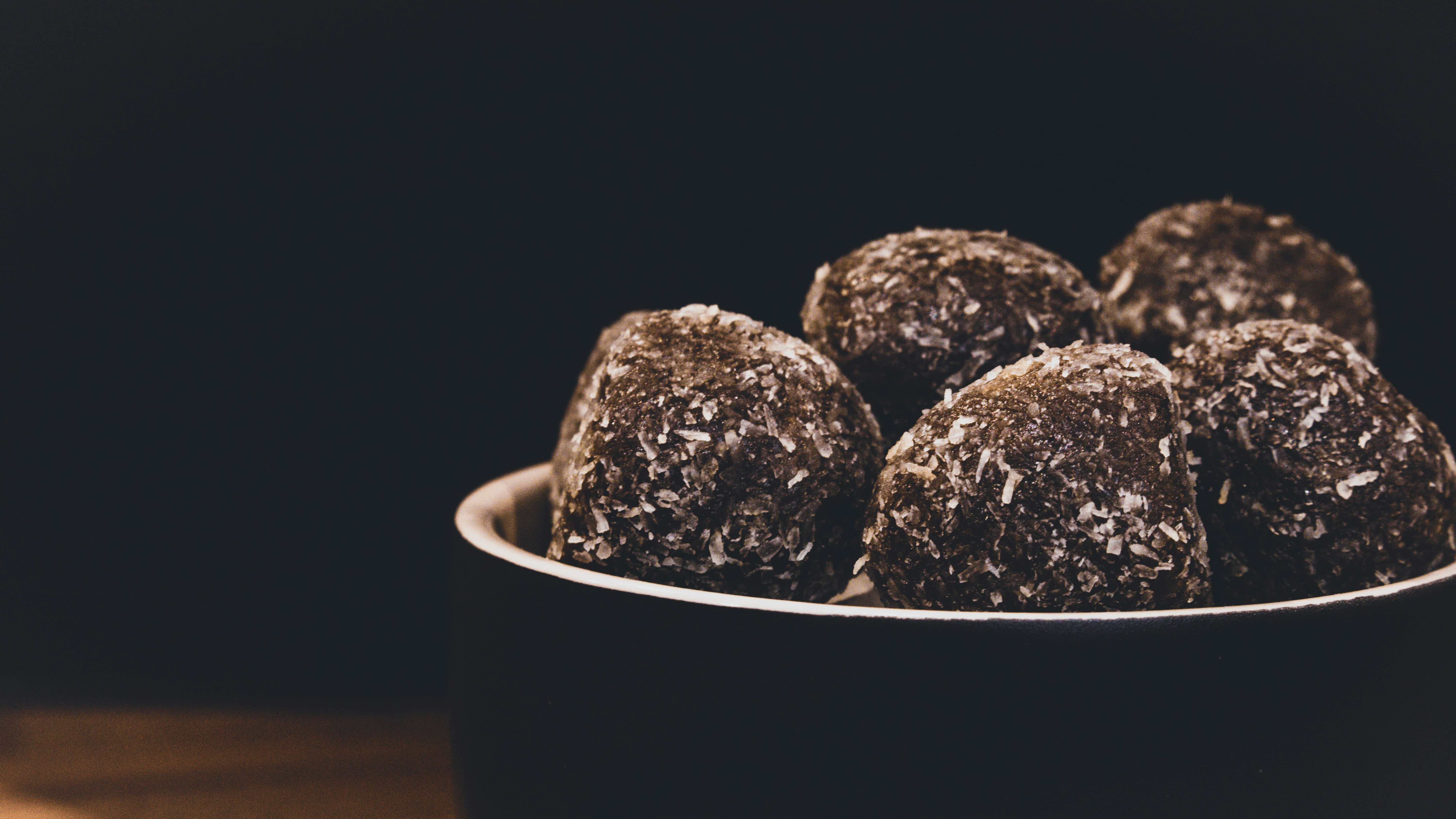 a bowl filled with oat and almond chocolate energy bites